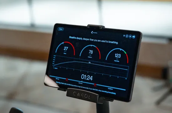A CAROL bike console displaying power, cadence and heart rate readings during a sprint interval