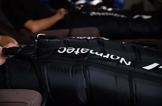 Close-up of a Normatec compression therapy boot with its control unit attached