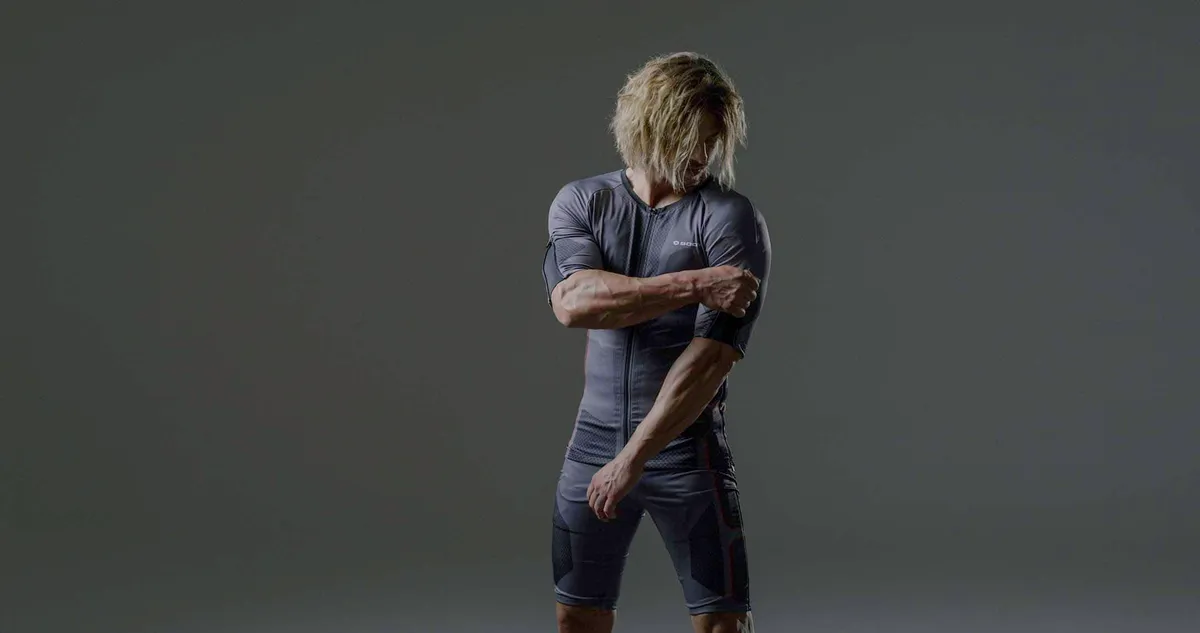 A man wears a full-body electric muscle stimulation training suit